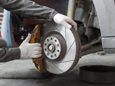 side view worker repairing car